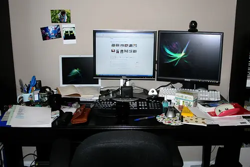 A laptop screen crowded with many open browser tabs