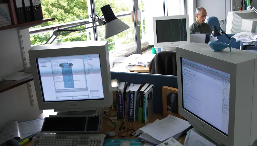 A desk with two monitors of different sizes side by side