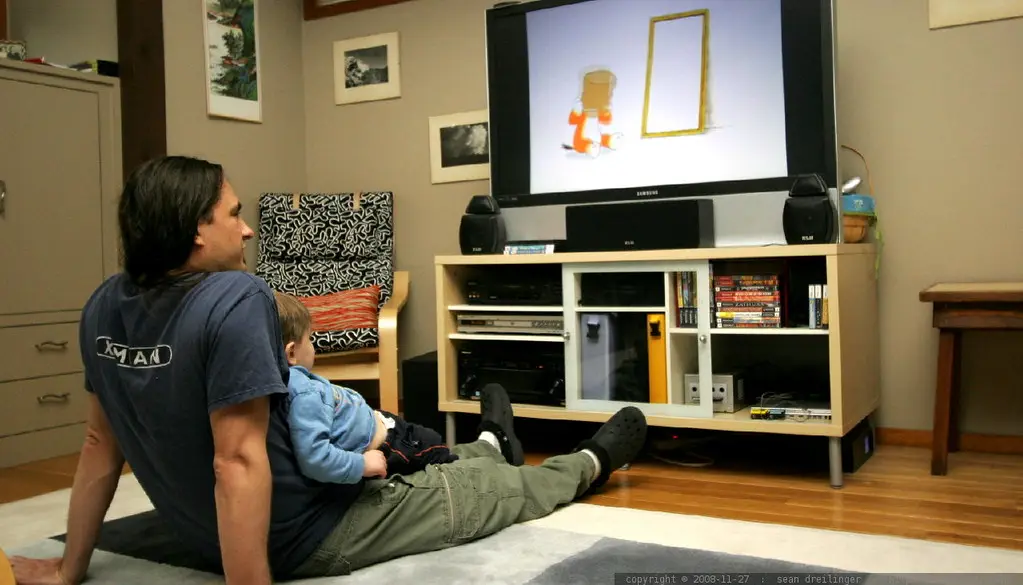 A family watching a movie together on a living-room TV