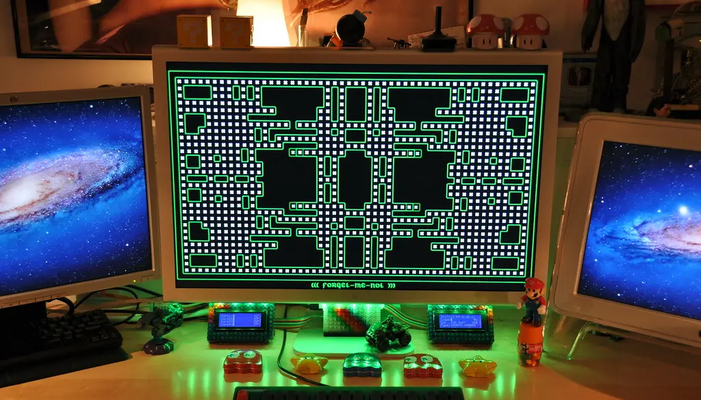 An OLED gaming monitor displaying deep blacks and bright highlights in a dark room