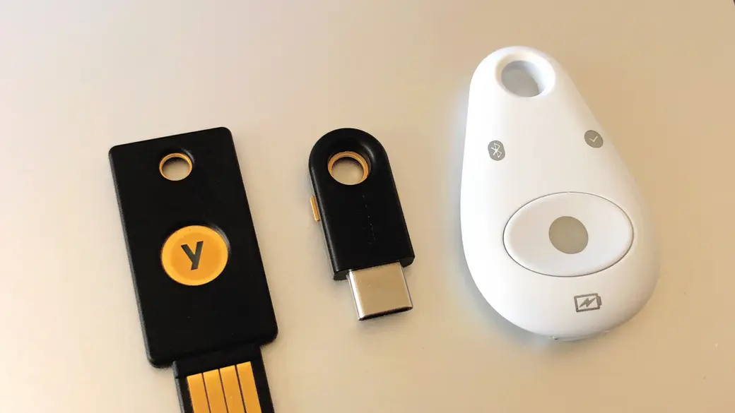 A USB-C hardware security key plugged into a laptop