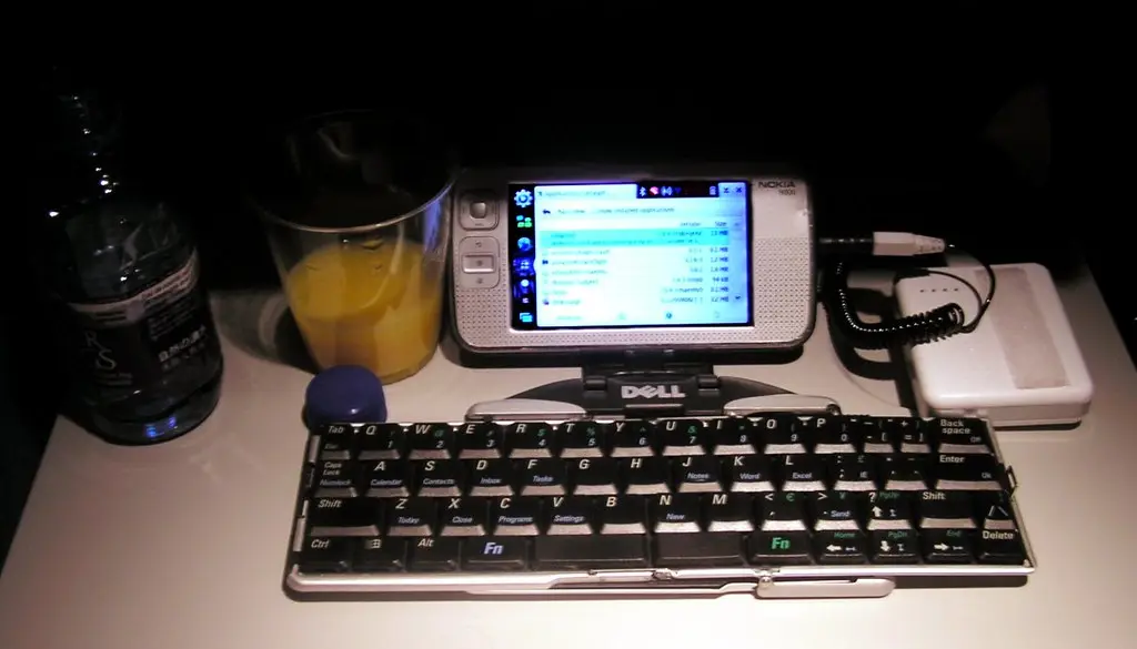 A mesh Wi-Fi node sitting on an open shelf in a living room