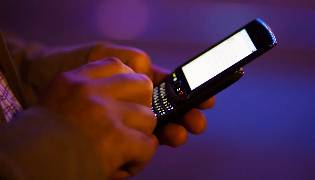 A person typing a message on a smartphone